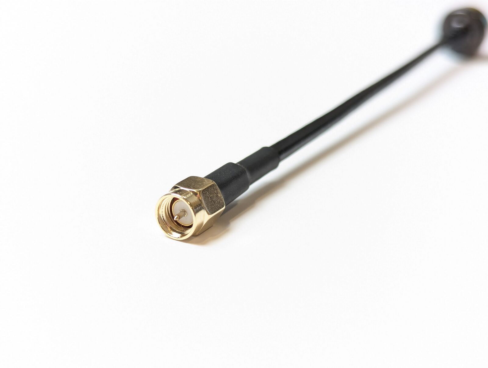 A5800 SMA connector close-up — gold-plated male center pin with 8mm hex and heat-shrink strain relief